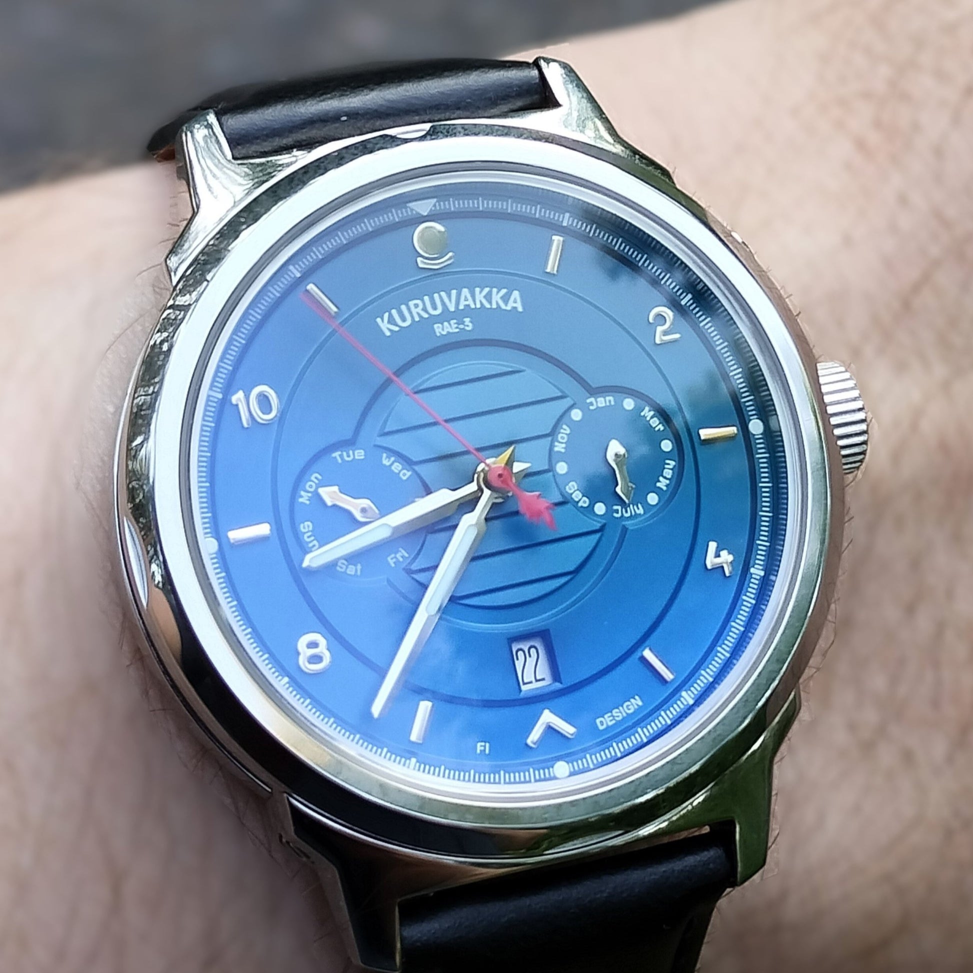 Shiny and with reflections image of the kuruvakka wristwatch. Close to the dial showing clearly the shapes and functions of the watch