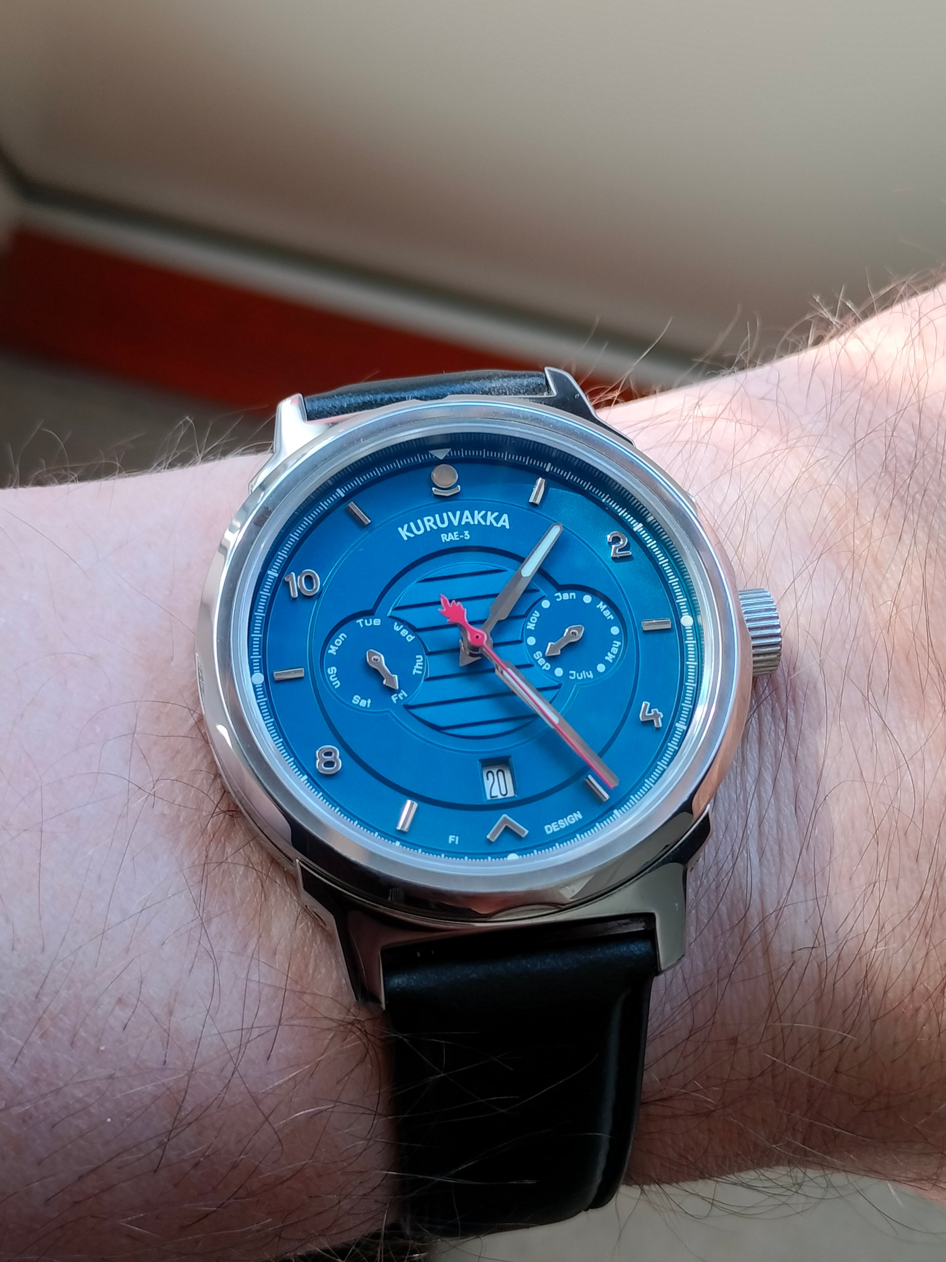 RAE-3 mechanical automatic wristwatch blue dial on a cloudy day