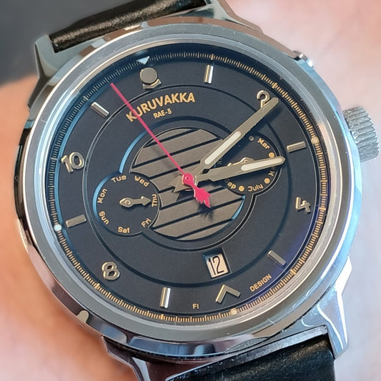 Close up image of a kuruvakka wristwatch showing the functions and complications of the dial.