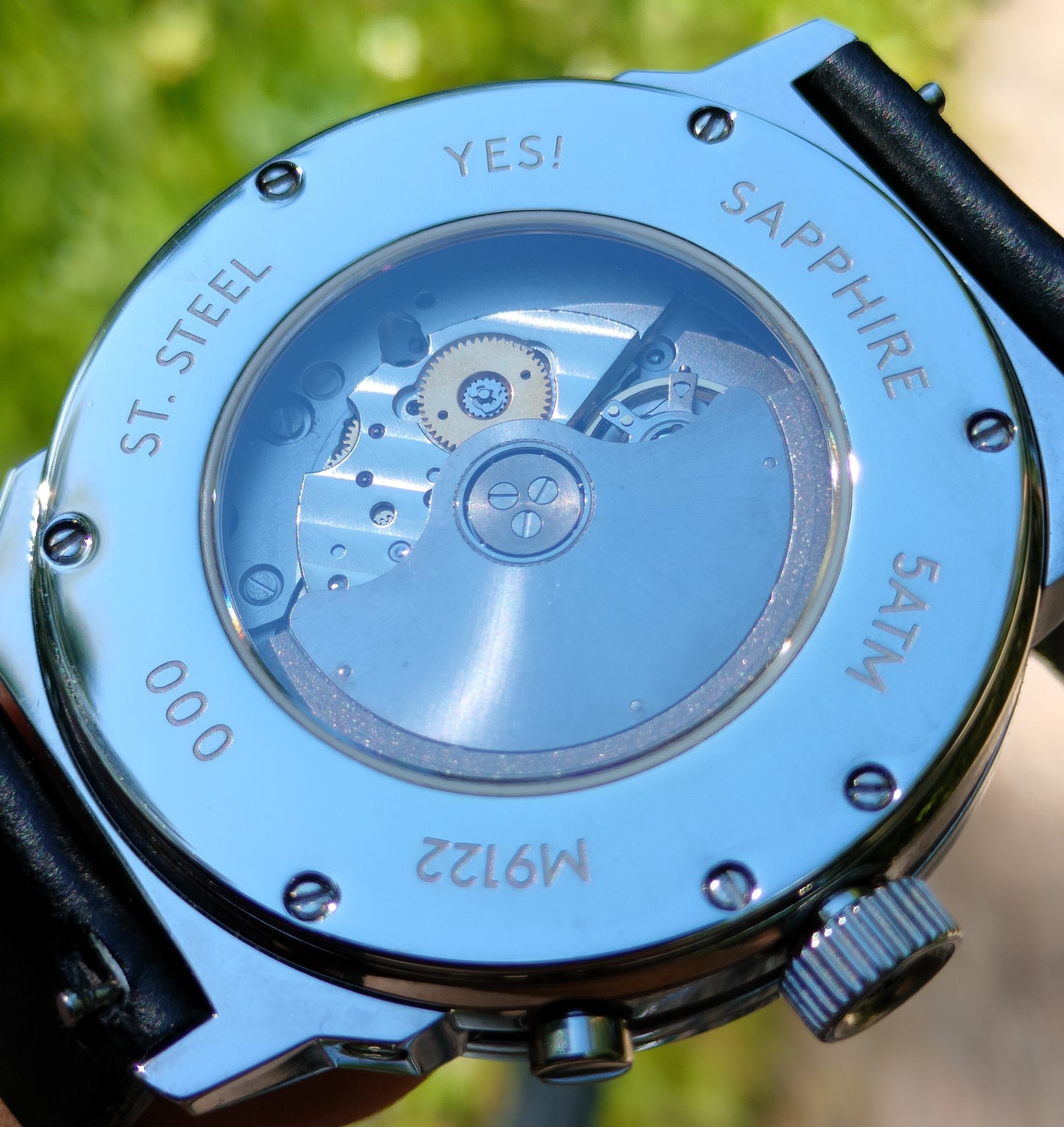 Kuruvakka wristwatch with mechanical movement showing the backside and its open caseback exposing the 9122 Miyota premium automatic movement.